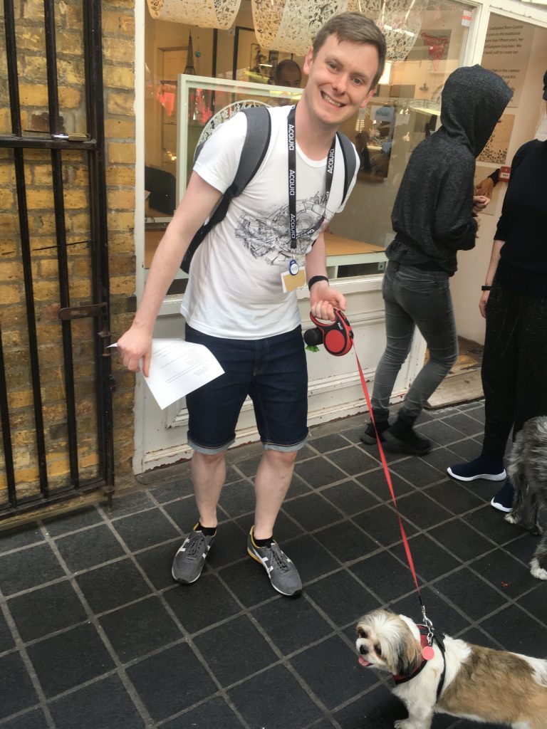 Pete from Dundee posing with a dog during the photo scavenger hunt
