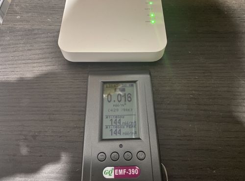 GQ EMF-390 positioned in front of WiFi router for RF measurement testing